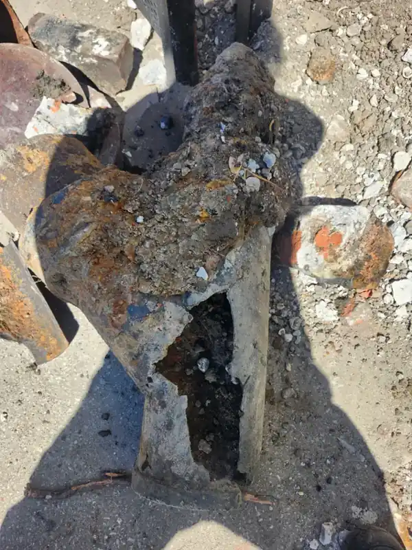 Broken cast-iron sewer fitting from a New Orleans plumbing repair