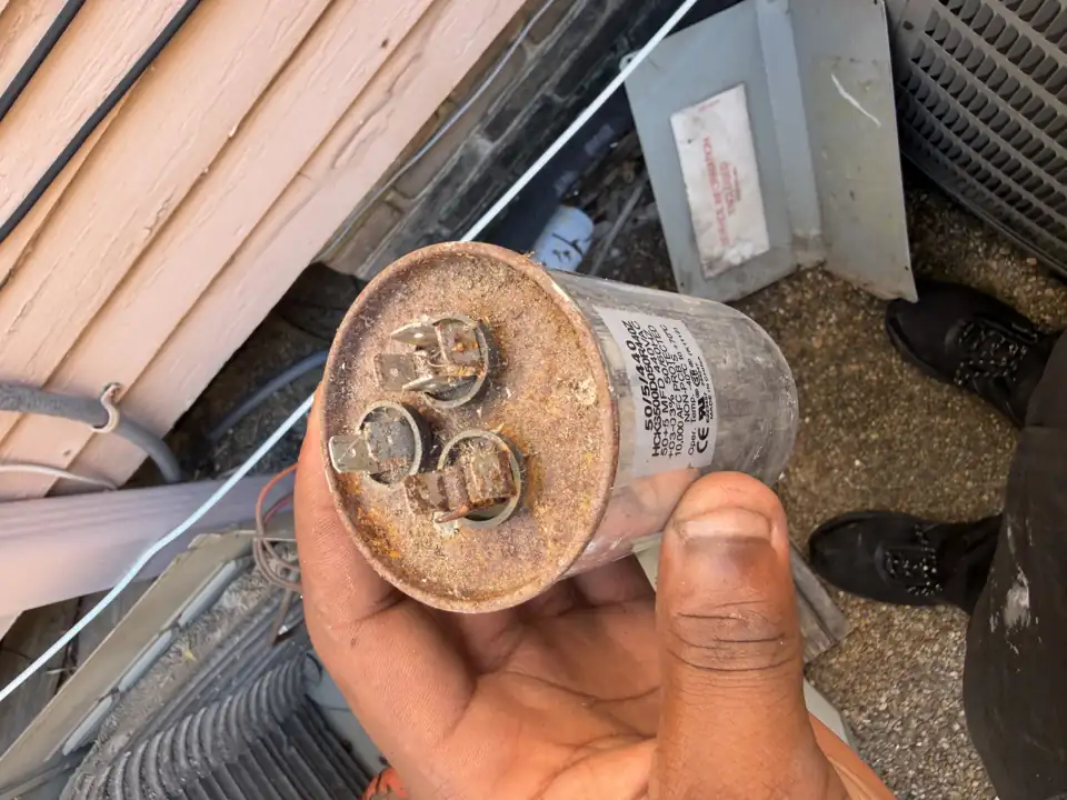 Rusted dual run capacitor removed from an outdoor unit