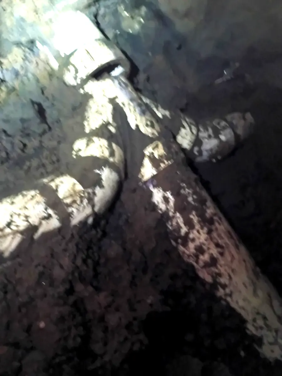 Corroded underground pipe before replacement in a New Orleans excavation